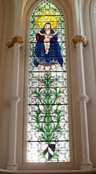 Stained Glass Window in the Hospital Church of St Bartholomew the Less: with coat of arms beneath.